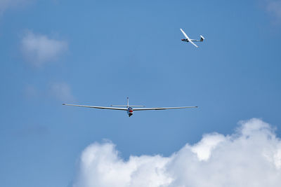 Low angle view of bird flying against sky