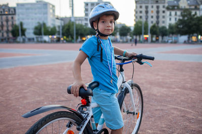 Side view of woman riding bicycle on street