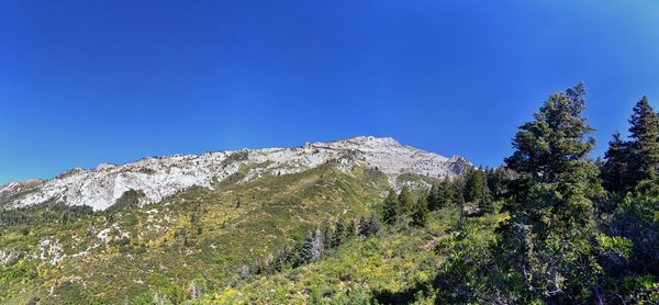 Low angle view of mountain against clear blue sky