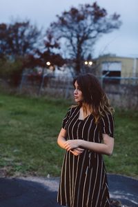 Fashionable teenage girl standing outdoors