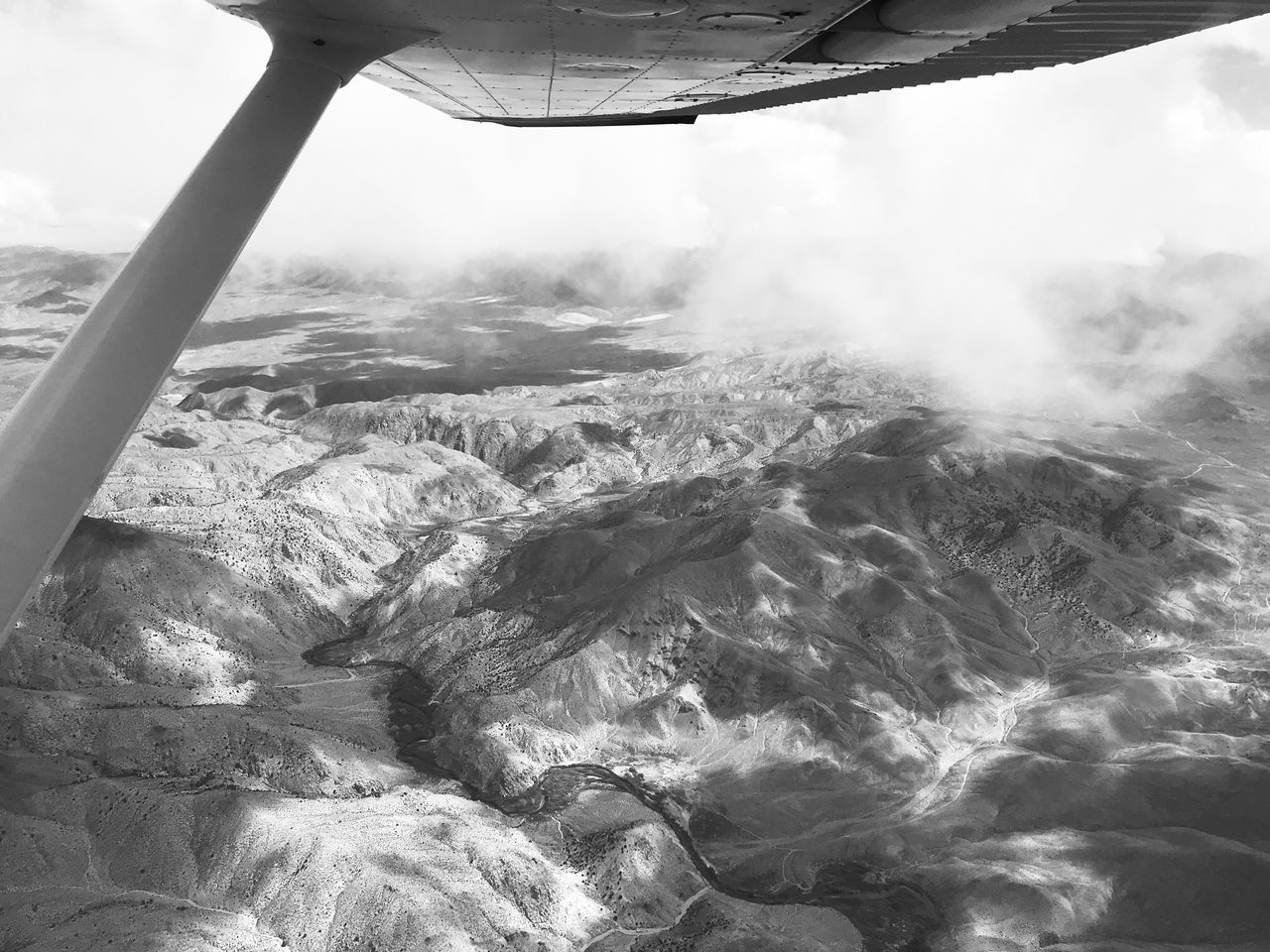 AERIAL VIEW OF LANDSCAPE SEEN THROUGH AIRPLANE