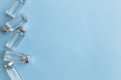 Close-up of electric lamp on table against blue wall