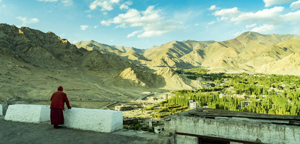 Rear view of woman on landscape against sky