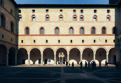 Group of people walking in historic building