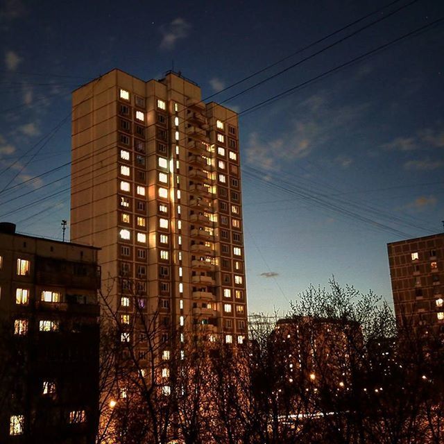 building exterior, architecture, built structure, city, illuminated, sky, low angle view, night, building, residential building, power line, tall - high, dusk, residential structure, skyscraper, cloud - sky, modern, tower, no people, outdoors