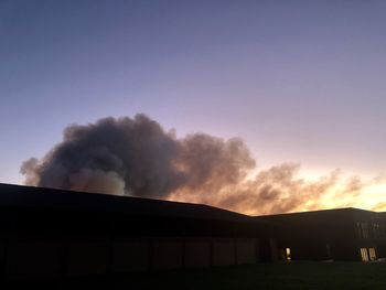 Low angle view of smoke emitting from chimney against sky