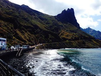 Scenic view of sea and mountains against sky