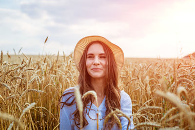 Portrait of young woman standing in farm