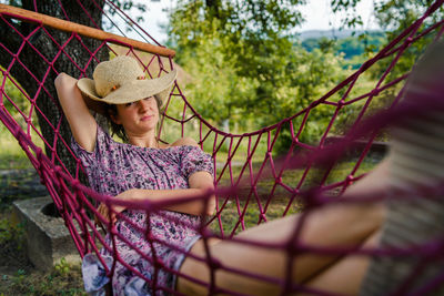 Portrait of woman relaxing on hammock