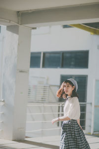 Portrait of woman walking in corridor