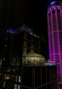 Low angle view of illuminated buildings at night