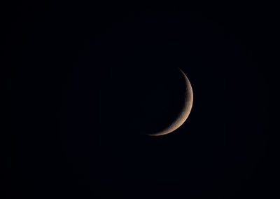 Low angle view of half moon against sky at night