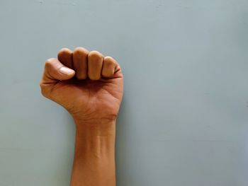 Close-up of person hand against white background