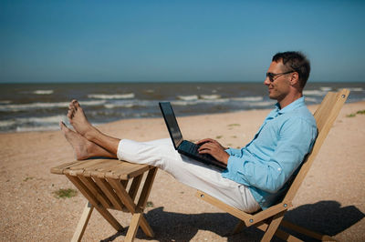 Businessman working on beach