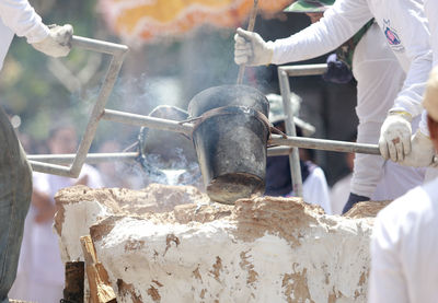 People working on barbecue grill