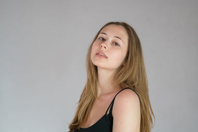 Portrait of a beautiful young woman over white background