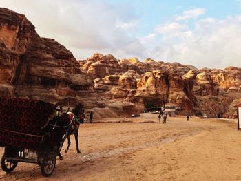 People at historical petra against sky