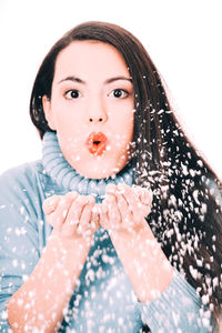 Portrait of woman with ice cream in snow