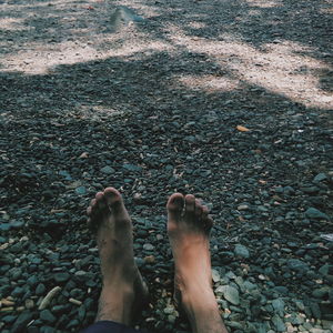 Low section of person standing on rock