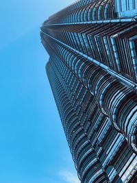 Low angle view of modern building against clear blue sky