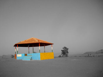 Built structure on beach against clear sky