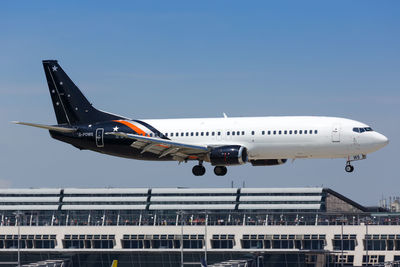 Airplane flying against sky