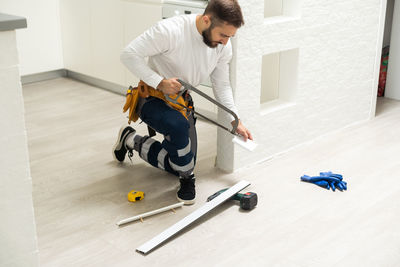 High angle view of boy playing with toy on floor