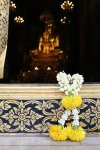 Close-up of white statue on table in temple