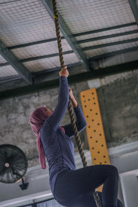 Low section of woman with umbrella on ceiling