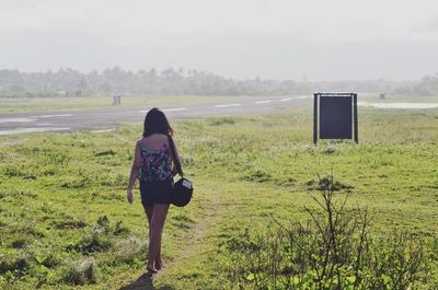 Scenic view of grassy field against sky