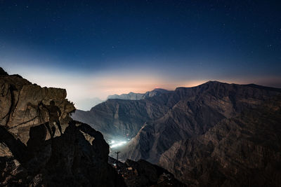 Scenic view of mountains against sky at night