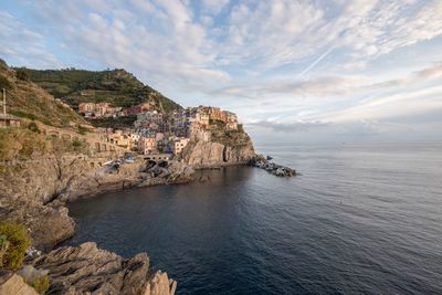 Scenic view of cliff and sea against sky