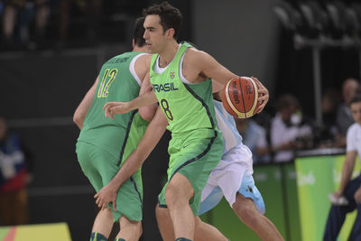 Man playing with basketball on court