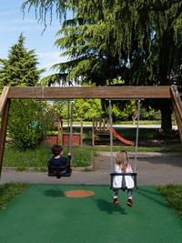 Rear view of a girl sitting in park