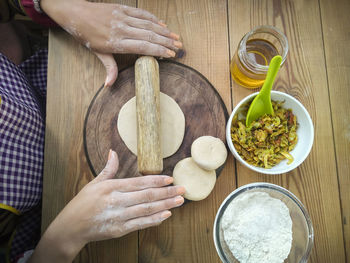 High angle view of woman preparing food on table