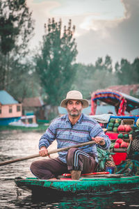 Portrait of smiling man sitting on boat
