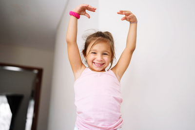 Girl posing for pictures with her hands up