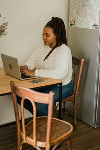 Young woman using laptop at home