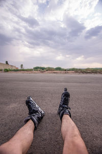 Low section of man with roller skates on road