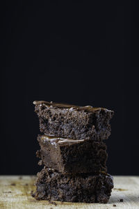 Close-up of cake on table against black background