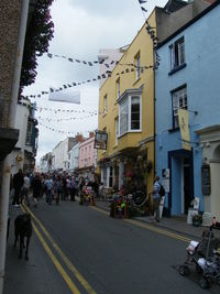 People on street in city against sky