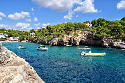 Boats moored on sea against sky