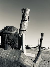 Wooden posts on beach against clear sky