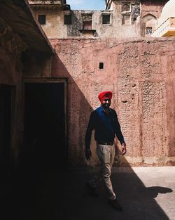 Full length of man walking on old building