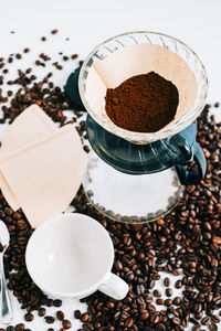 Fresh brewed coffee in a cup using alternative method, with pour over dripper and paper filter.