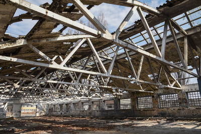 Low angle view of abandoned building against sky