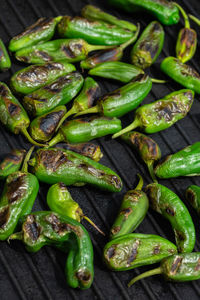 Grilled green hot mexican peppers jalapeno. typical spanish tapas, pimientos de padron
