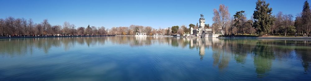 Scenic view of lake against clear blue sky