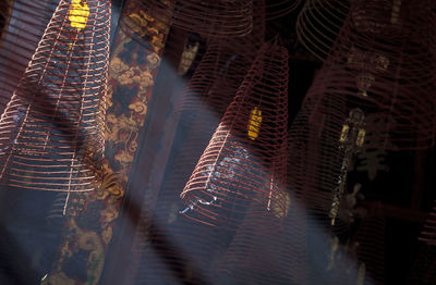 Low angle view of spiral incense sticks in temple