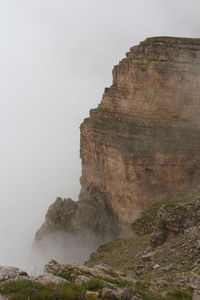 Low angle view of rock formations against sky